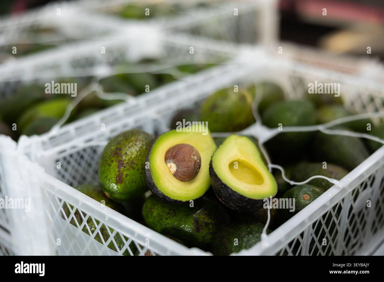 Fresh ripe sliced avocado on boxes close up Stock Photo