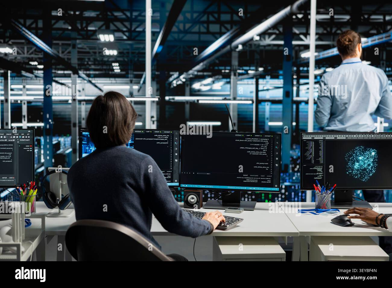 System administrator inspects server infrastructure, performs maintenance checks and reviews equipment diagnostics. Stock Photo