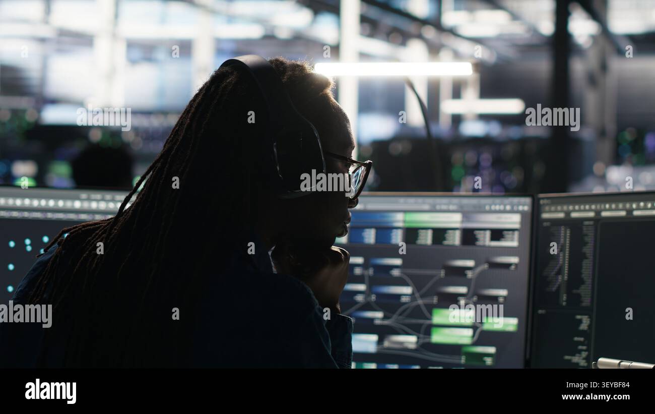 Data center engineer manages databases supporting AI applications and data mining in a server facility. Stock Photo