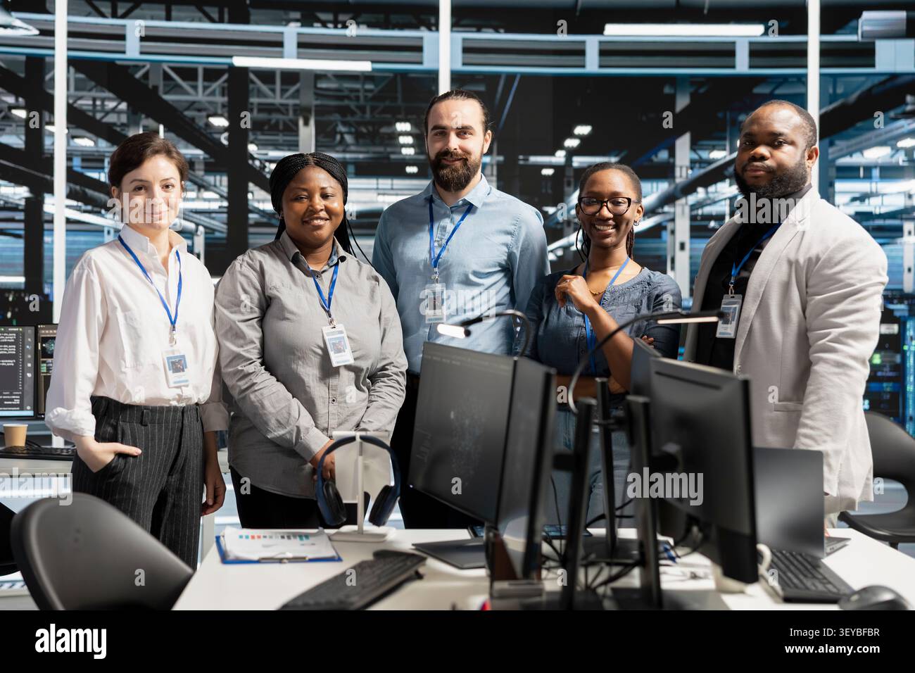 Positive engineering team in data infrastructure center managing server virtualization, running scripts. Stock Photo