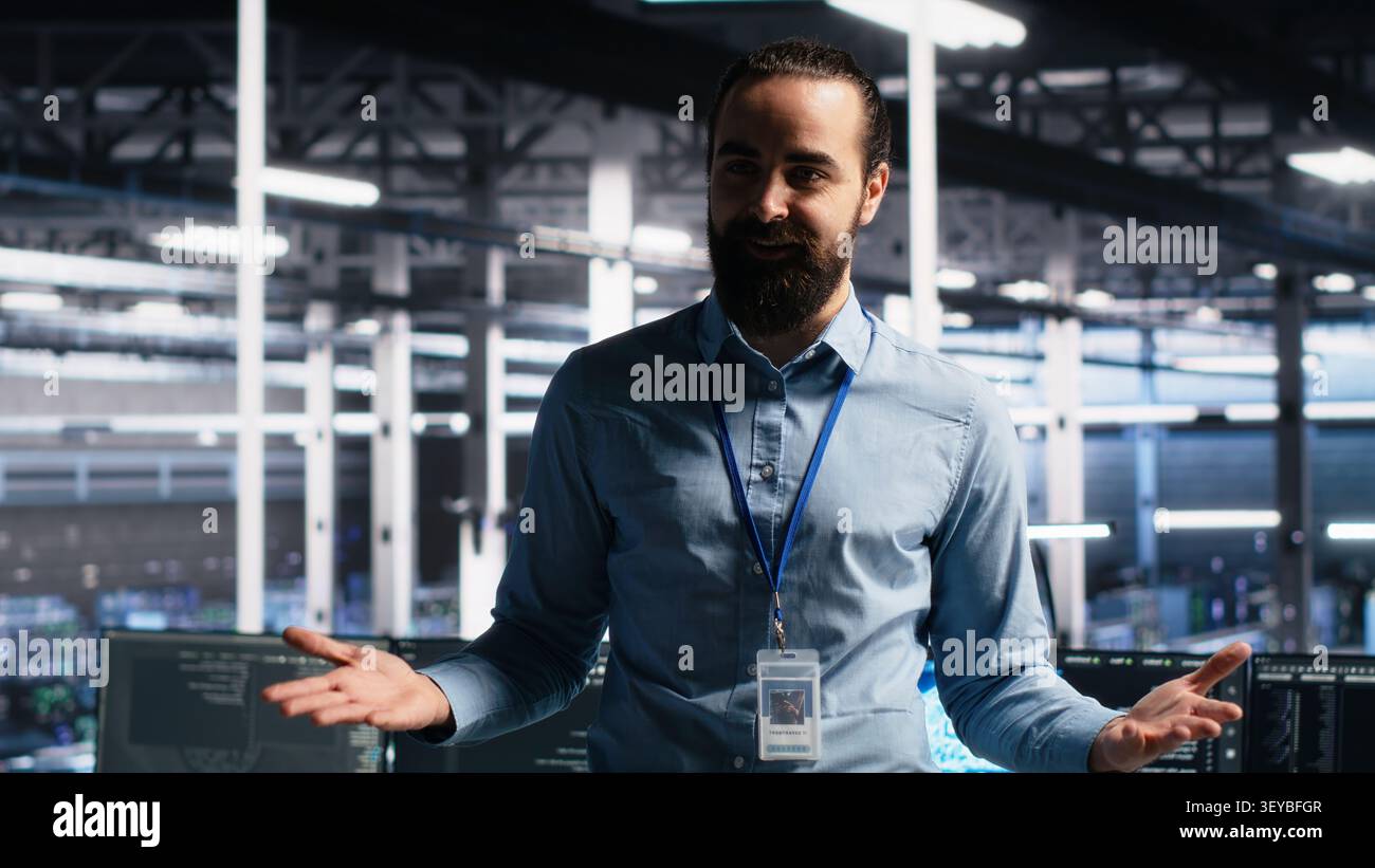 Data center manager presents AI technology and server room hardware during a data center demonstration. Stock Photo