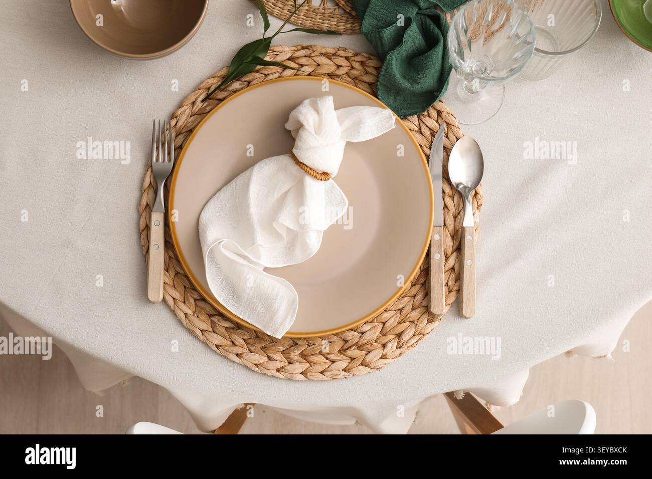 Elegant table setting with napkin folded like a bunny Stock Photo