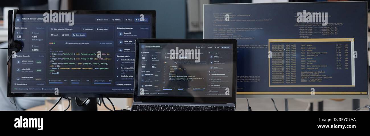 Computer Monitors Displaying Software Code in Information Technology Office Stock Photo