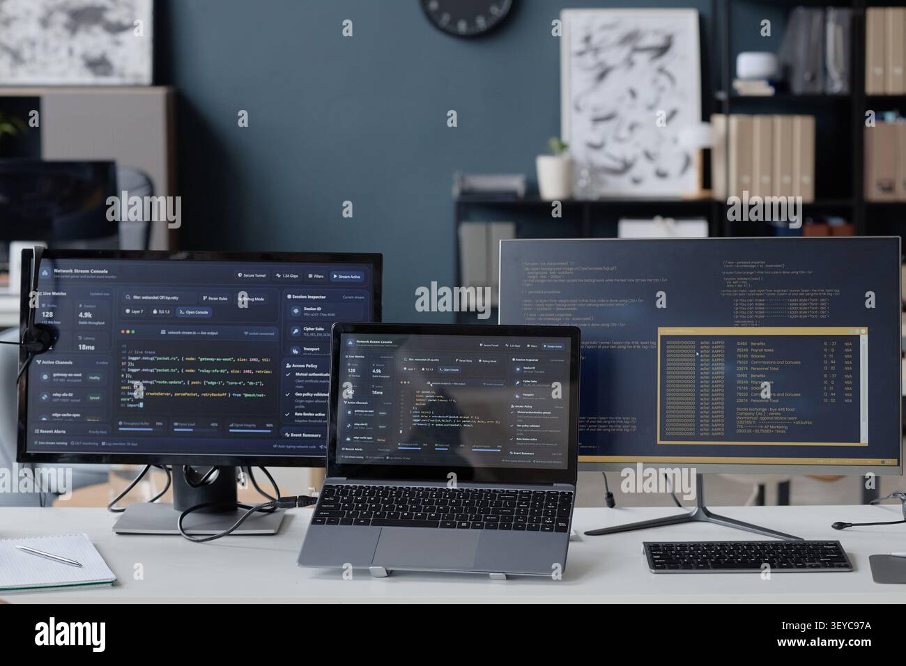 Developer Workstation Displaying Code for Cybersecurity Monitoring Stock Photo