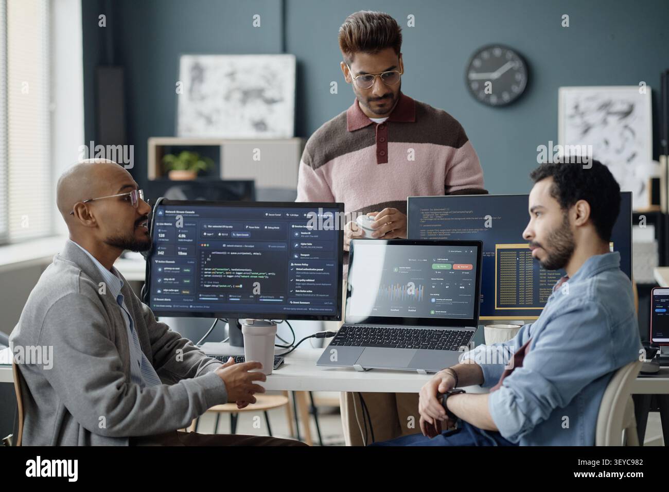 Diverse Men Collaborating on Software Development in it Office Stock Photo