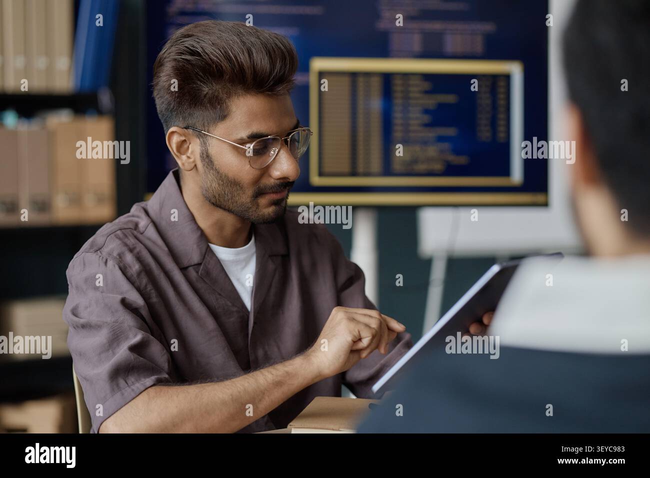 Man Using Tablet during Office Collaboration Meeting Stock Photo