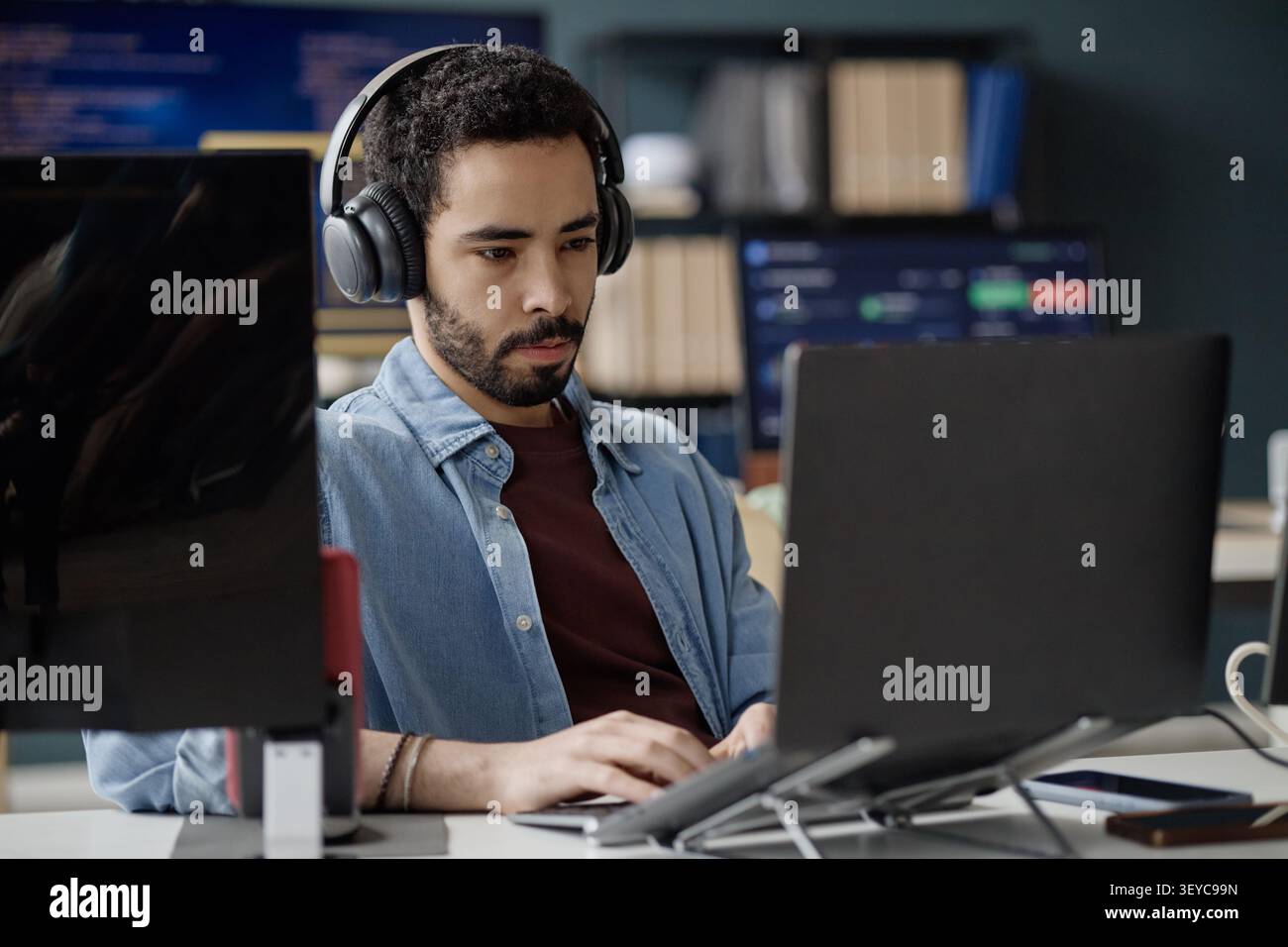 Man Working on Laptop in Information Technology Office Stock Photo