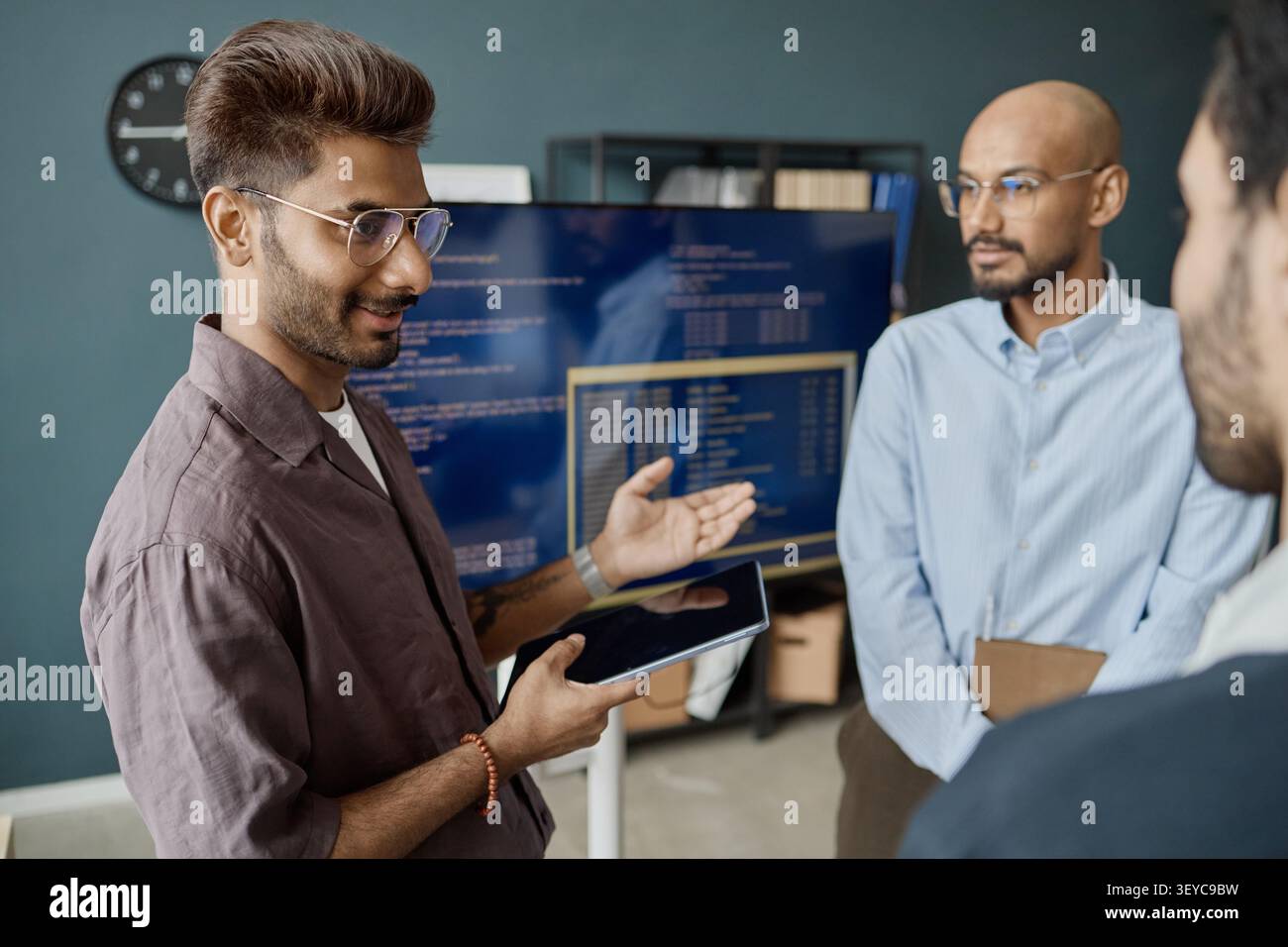 Indian Men Discussing Software Project in Information Technology Office Stock Photo