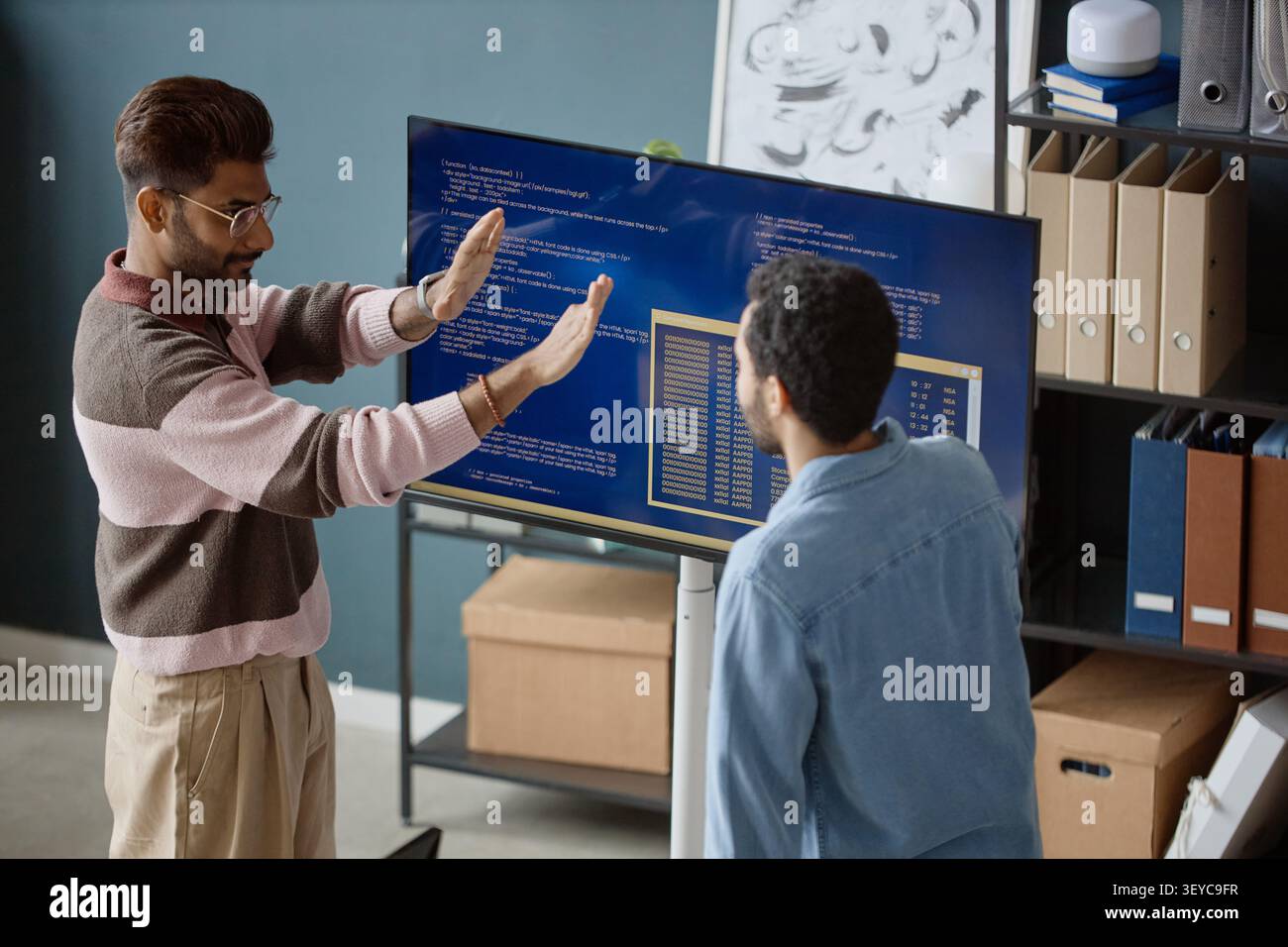 Adult Men Reviewing Software Code in Information Technology Office Stock Photo