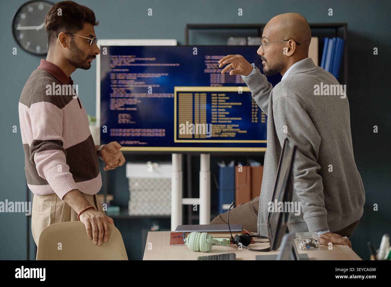 Adult Men Discussing Software Development Strategy in IT Office Stock Photo
