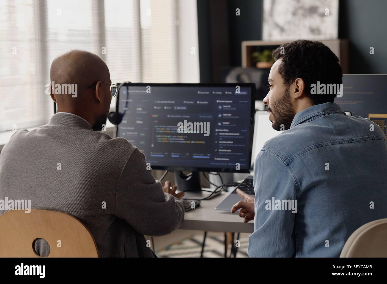 Men Reviewing Software Code in Information Technology Office Stock Photo
