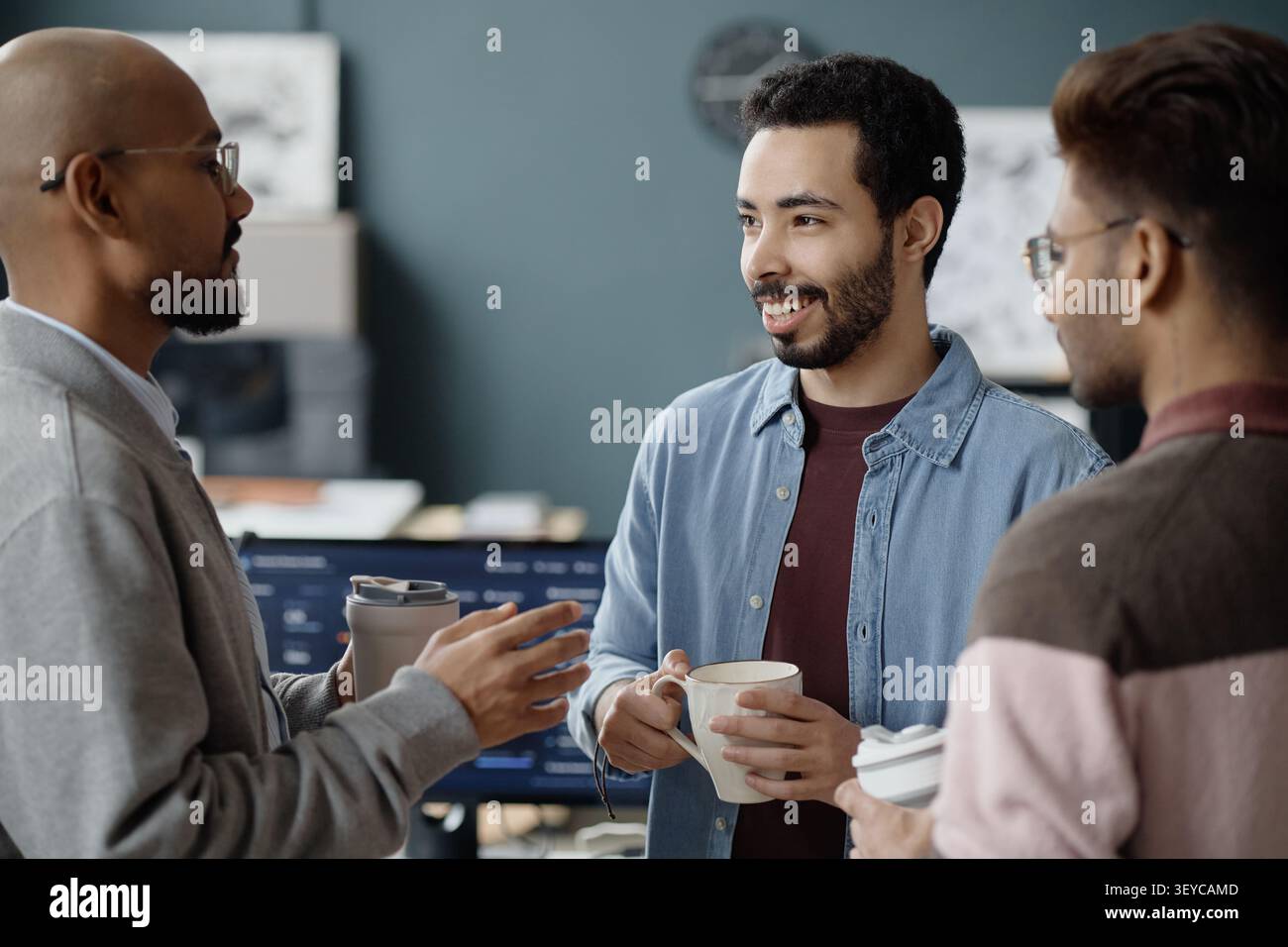 Multiethnic Men Discussing Project during Break in it Office Stock Photo