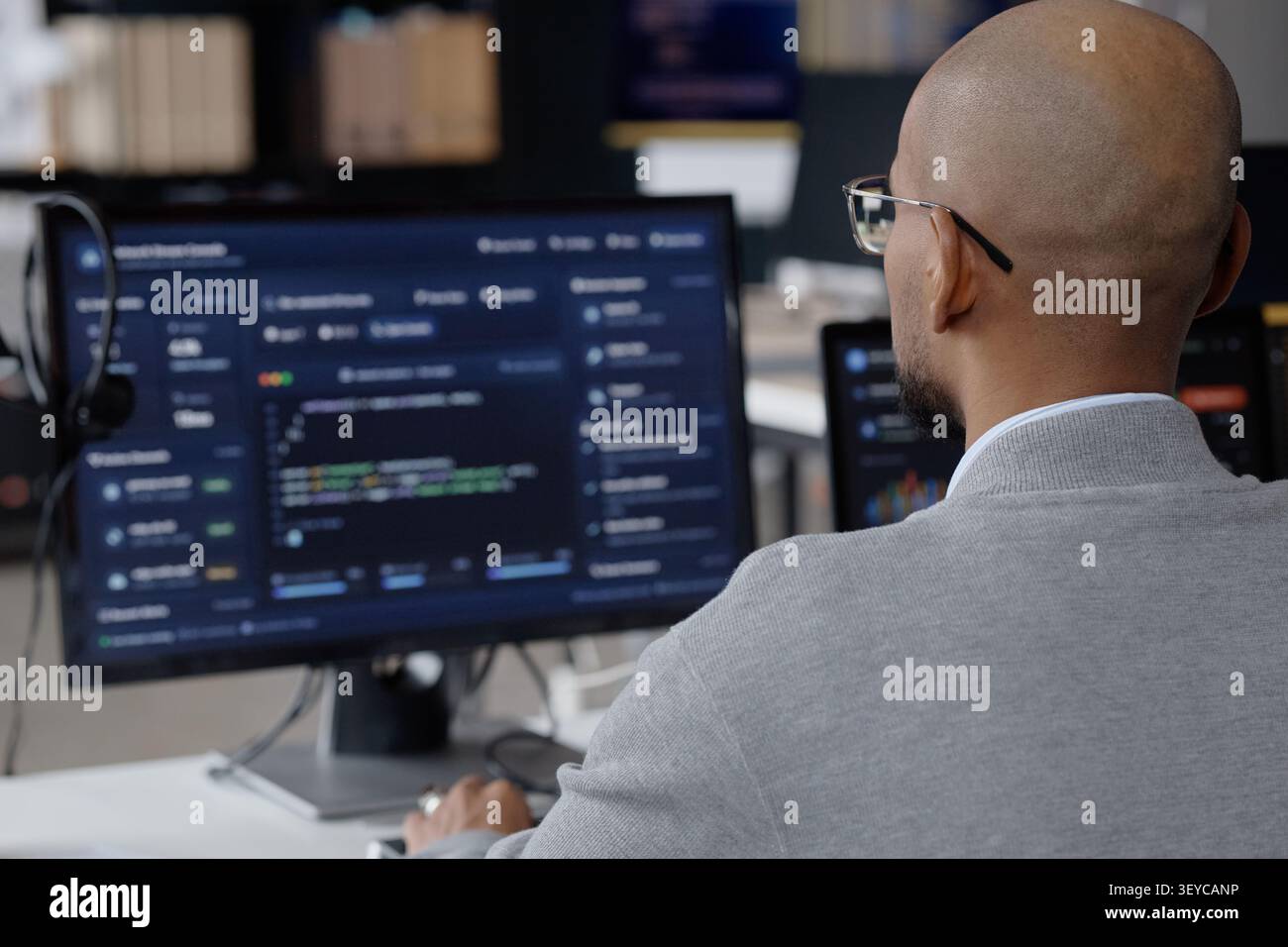 Middle Aged Man Analyzing Software Data in it Office Stock Photo