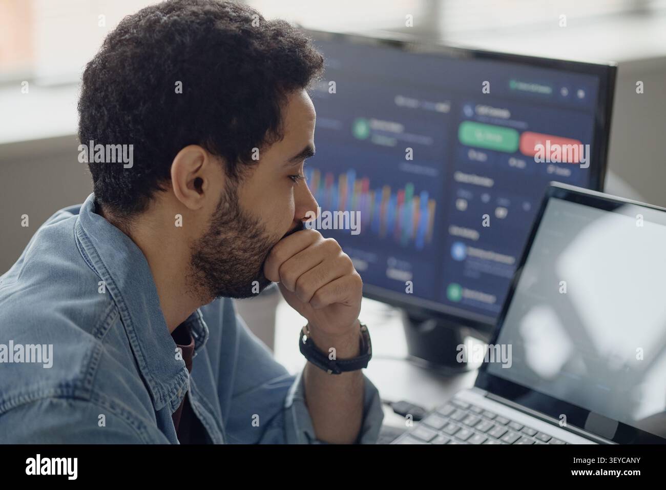 Man Analyzing Data Dashboard in Information Technology Office Stock Photo