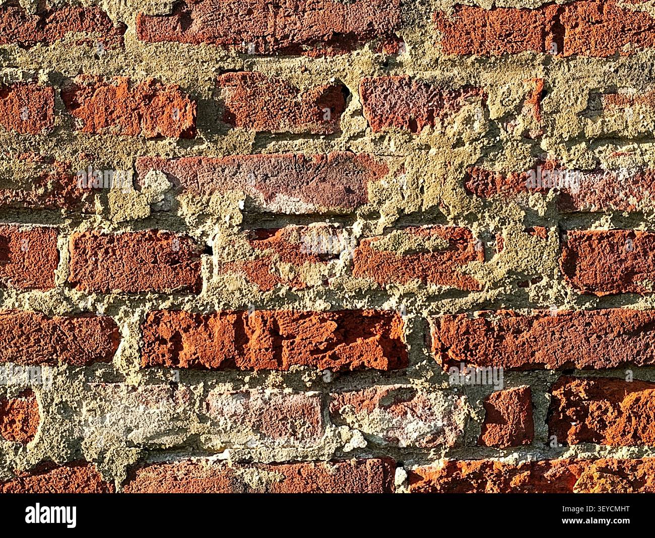 Old cracky bricks texture background in grazing light. Stock Photo