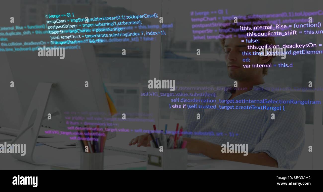 Male dev typing at desk while code overlay appearing, scrolling, obscuring screen for software Stock Photo