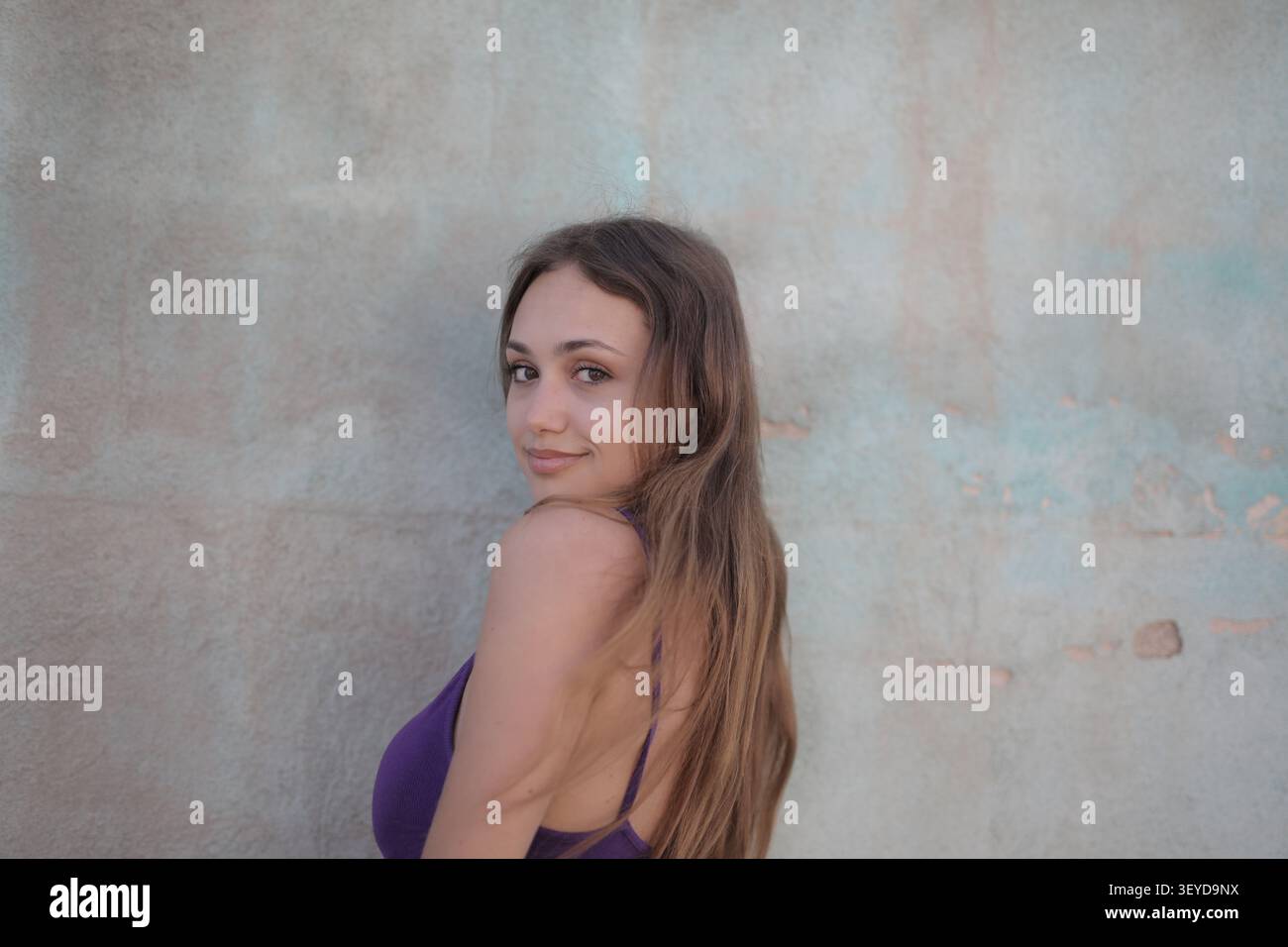 Young woman looking back over her shoulder Stock Photo