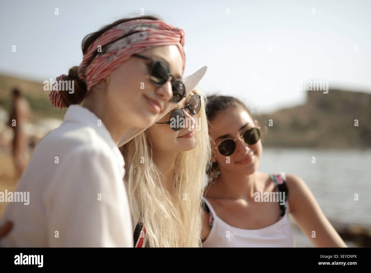 Three girlfriends in sunglasses enjoying the sunshine Stock Photo