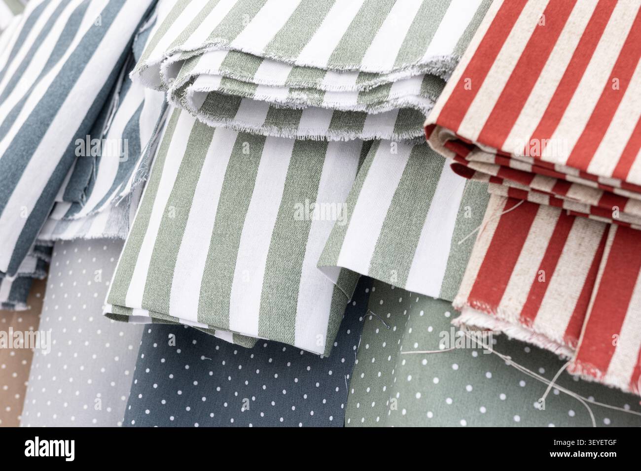 assorted striped and polka dot pattern fabric rolls background Stock Photo