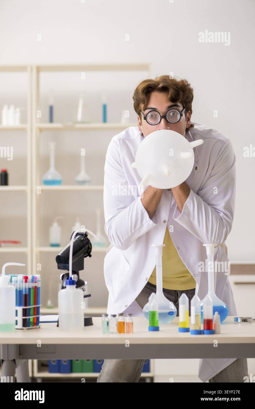 Funny crazy chemist doing experiments and tests Stock Photo
