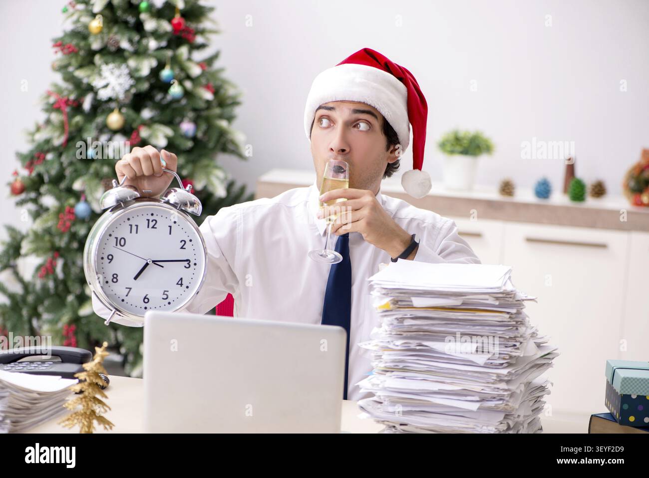 Young worker working in office on christmas shift Stock Photo