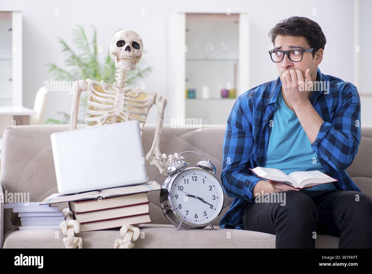 Student studying with skeleton preparing for exams Stock Photo
