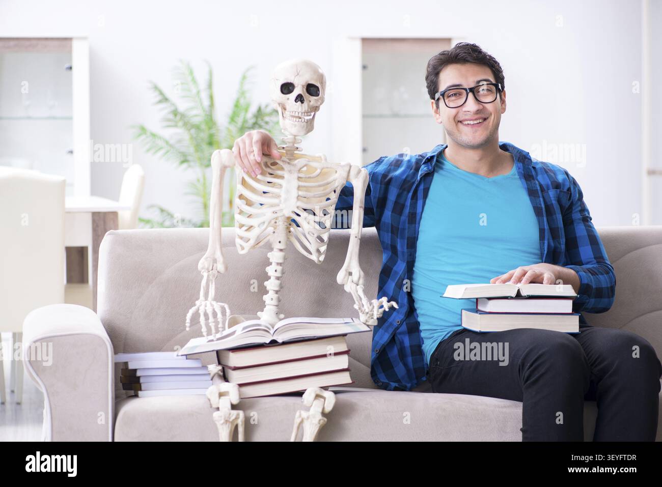 Student studying with skeleton preparing for exams Stock Photo