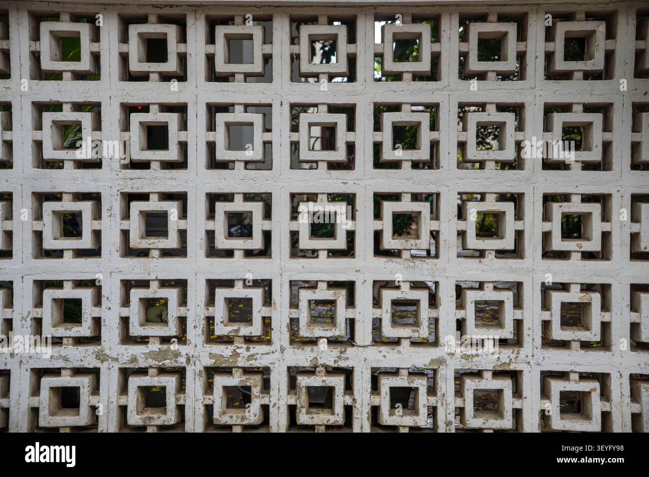 Decorative concrete breeze block wall with repeating square pattern Stock Photo