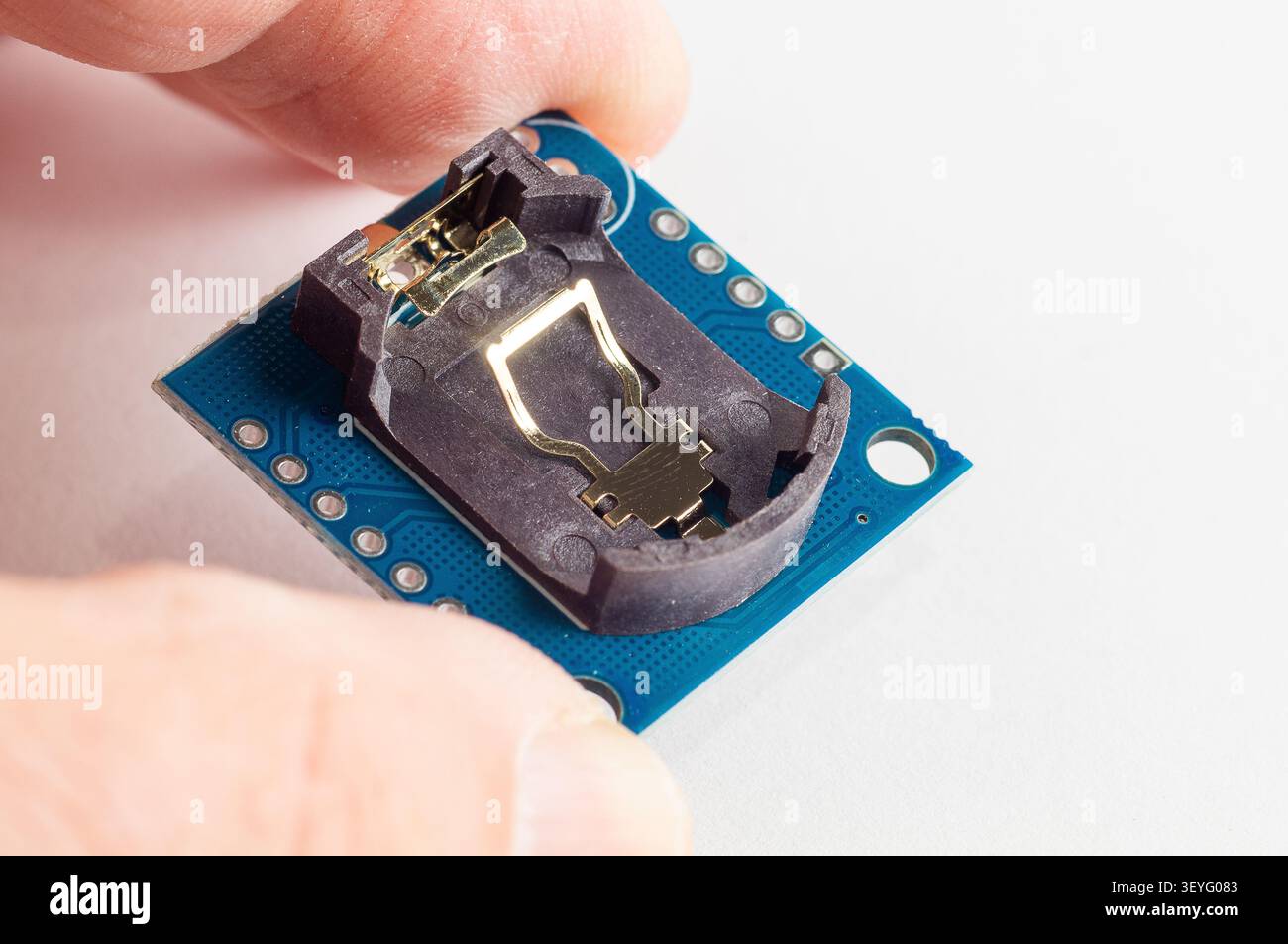 Real Time Clock Module For AVR ARM PIC Tiny RTC I2C modules memory DS1307 Clock in hand Stock Photo