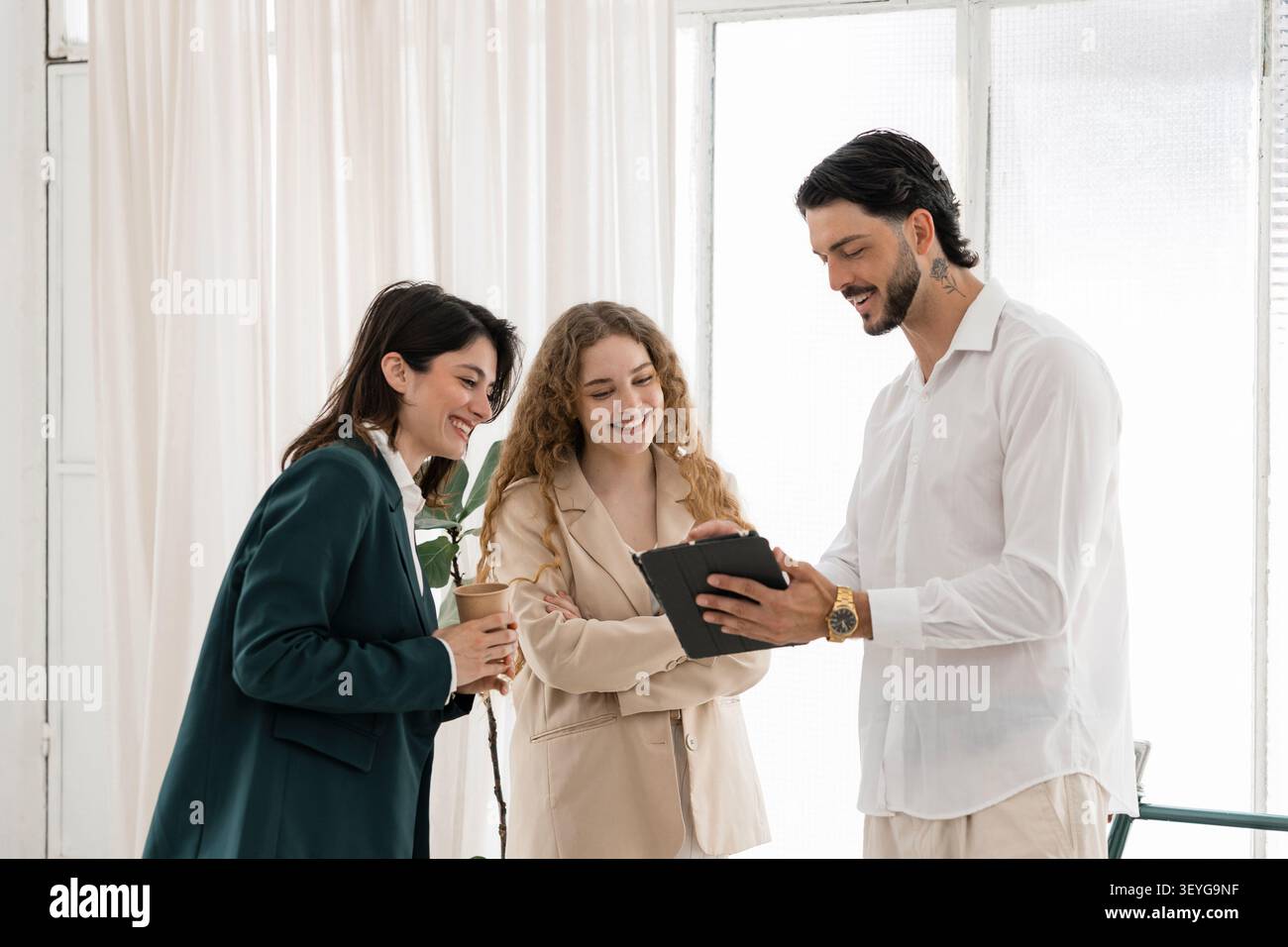Business colleagues discussing data on digital tablet Stock Photo
