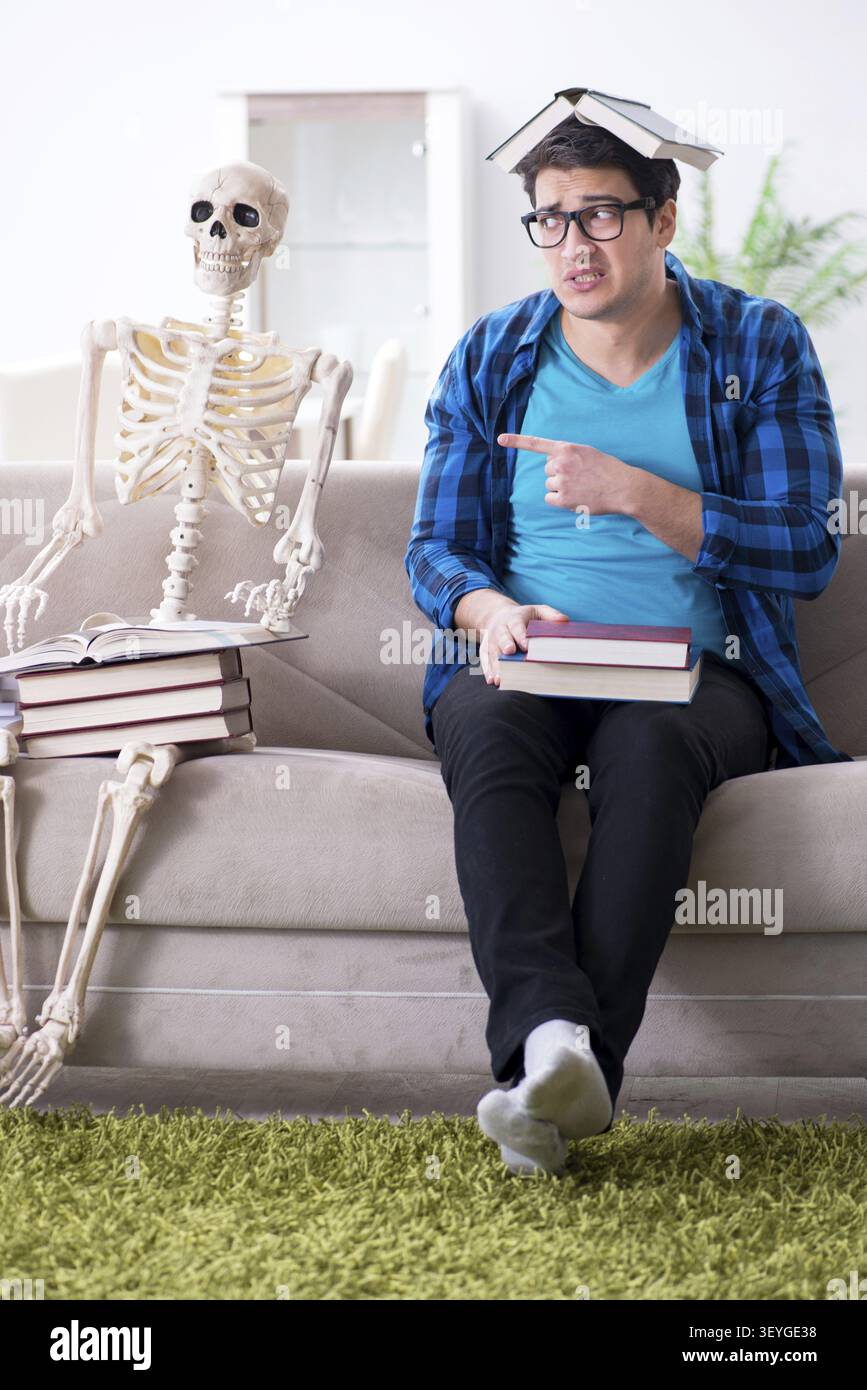 Student studying with skeleton preparing for exams Stock Photo