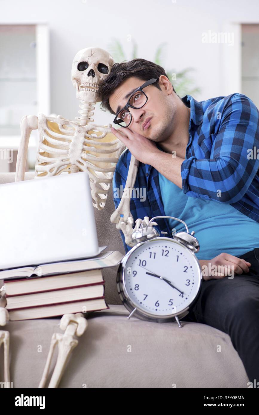 Student studying with skeleton preparing for exams Stock Photo