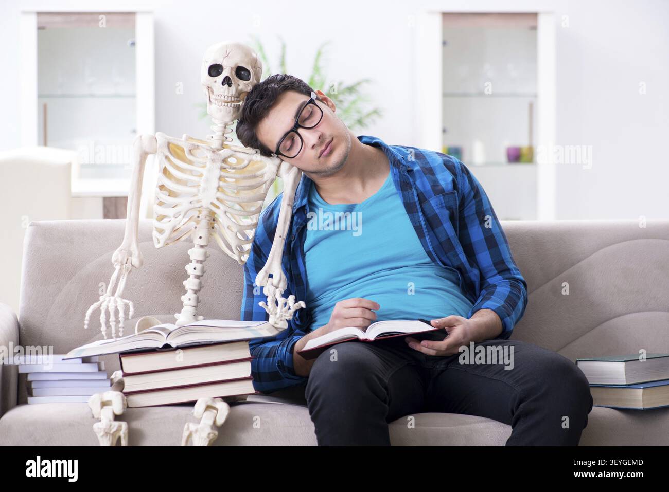 Student studying with skeleton preparing for exams Stock Photo