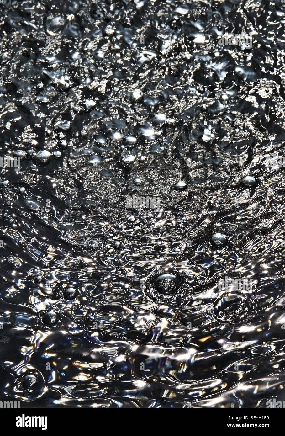 Air bubbles on dark water surface Stock Photo