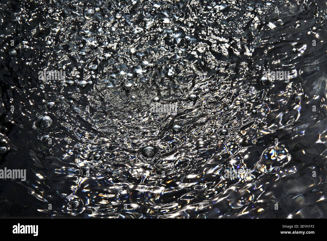 Air bubbles on dark water surface Stock Photo
