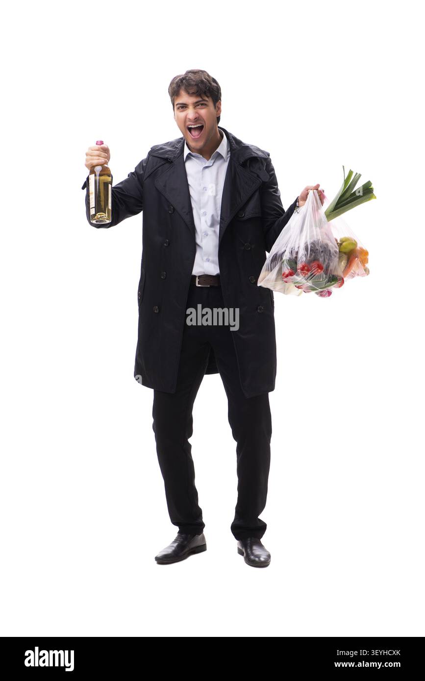 Young handsome man with vegatables in shopping concept Stock Photo