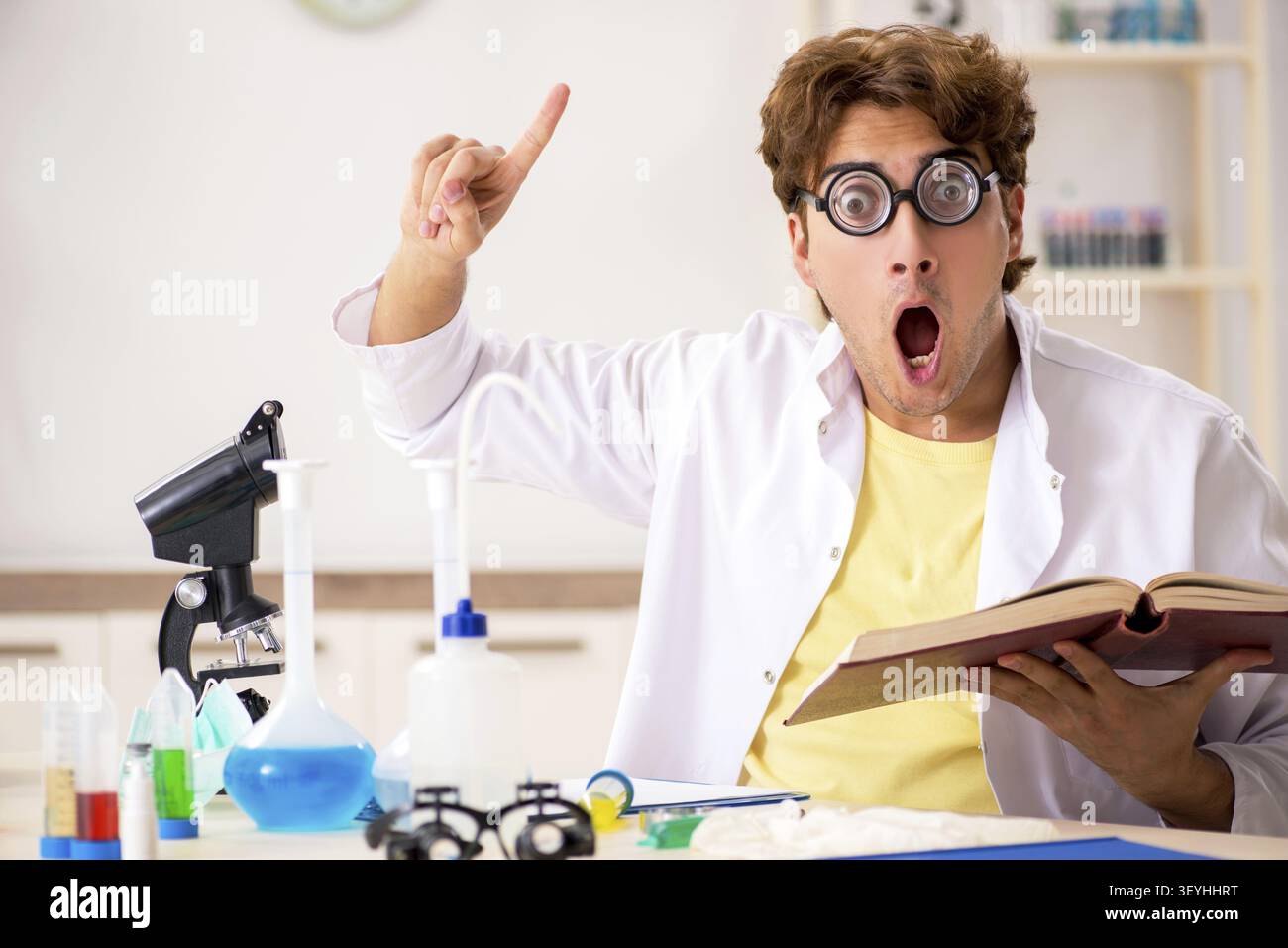 Funny crazy chemist doing experiments and tests Stock Photo