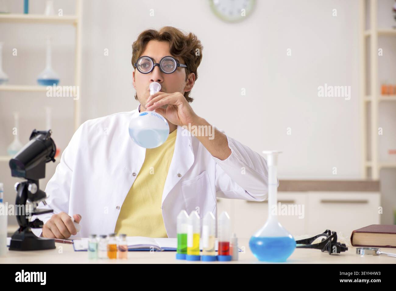 Funny crazy chemist doing experiments and tests Stock Photo