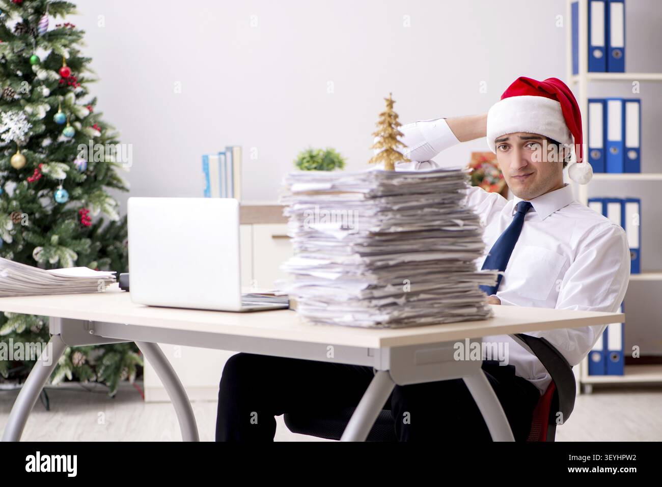 Young worker working in office on christmas shift Stock Photo