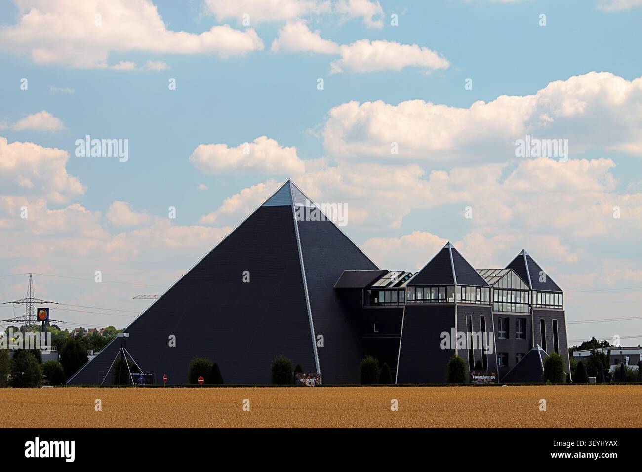 Mainz, Rhineland-Palatinate, Germany - July 2, 2026: Modern pyramid-shaped event venue viewed across agricultural fields Stock Photo