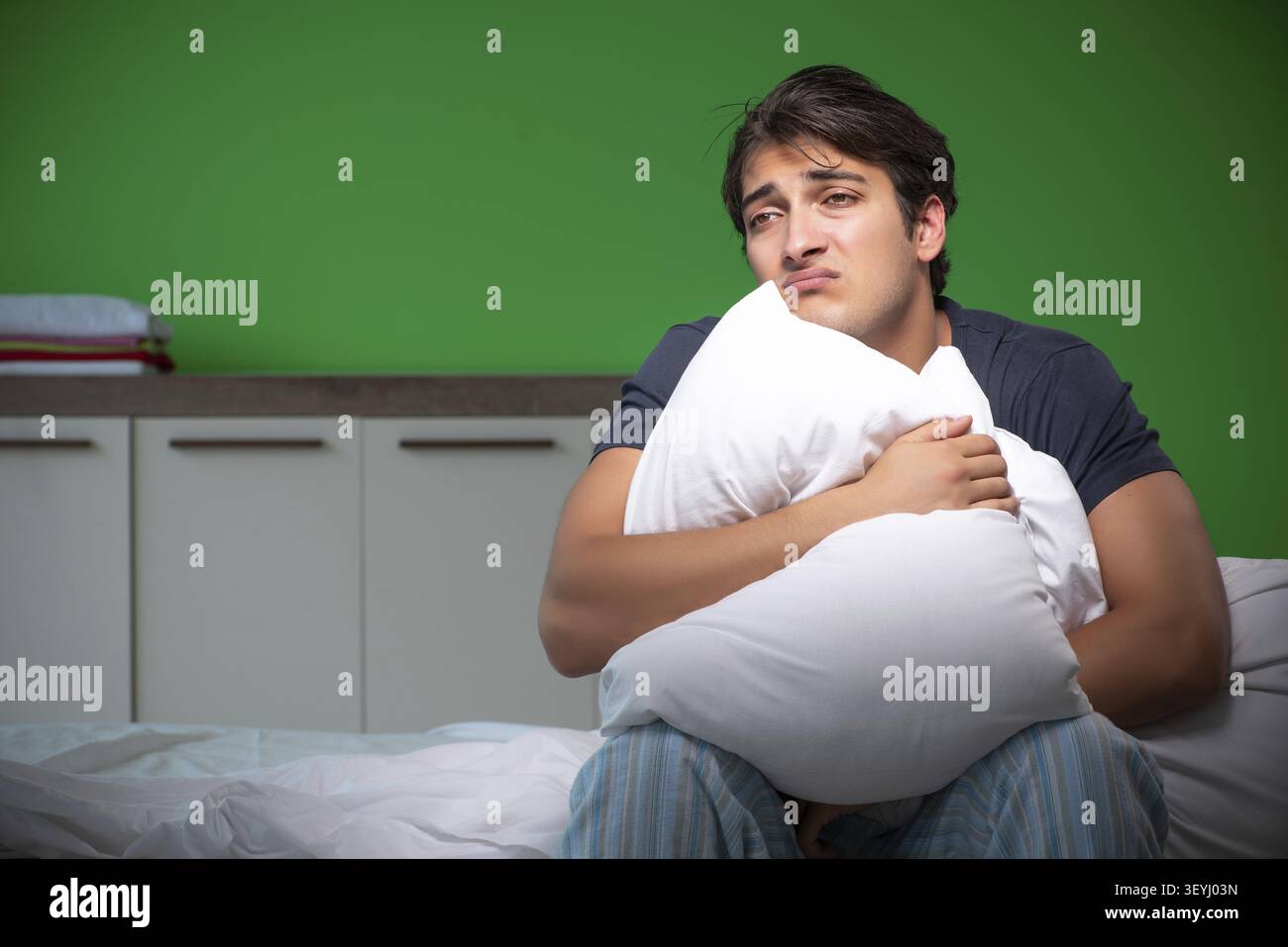 Young handsome man suffering from insomnia at home Stock Photo