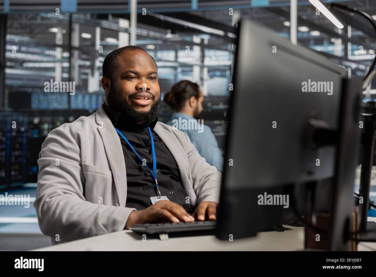 Pleased data center worker celebrates a successful server software update in a data center. Stock Photo