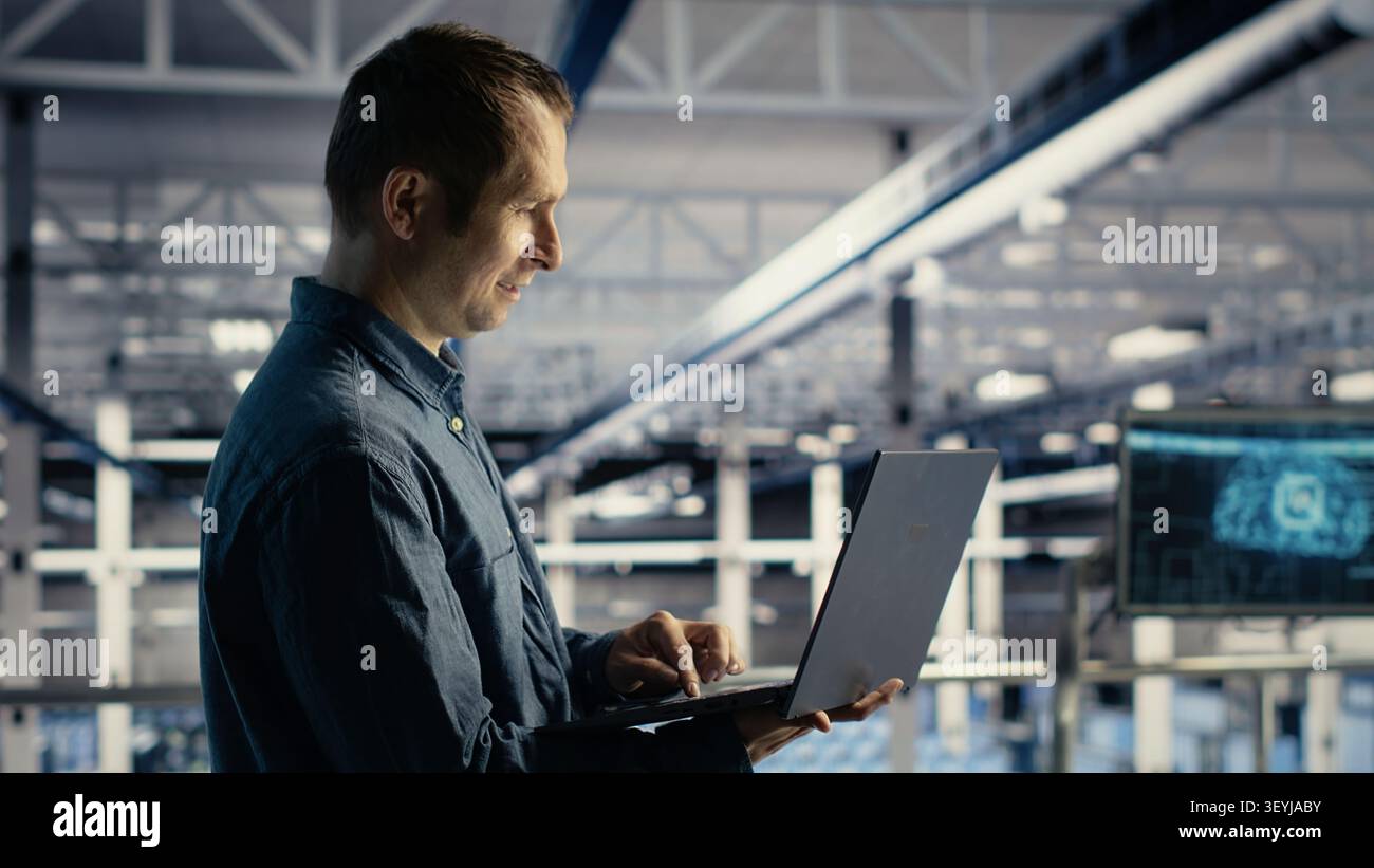 Data center engineer uses a laptop to manage AI training datasets and database workflows inside a server room. Stock Photo