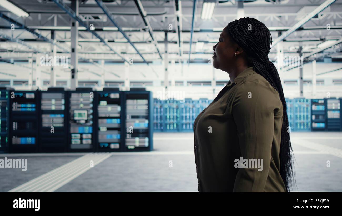 Data center manager oversees programmers reviewing AI diagnostics and machine learning systems. Stock Photo