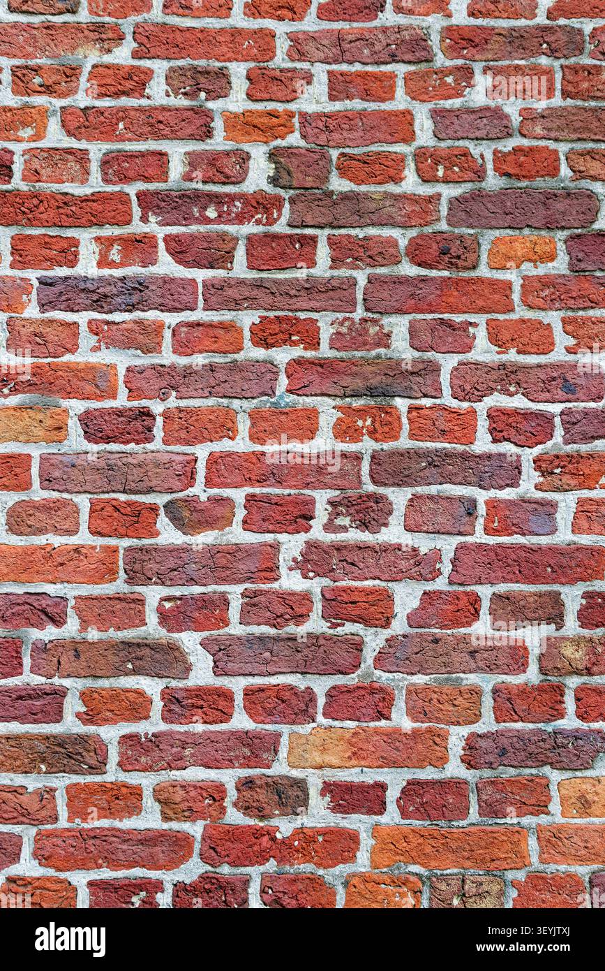 Full-frame red brick wall with light mortar joints and regular masonry pattern for texture or background use. Stock Photo