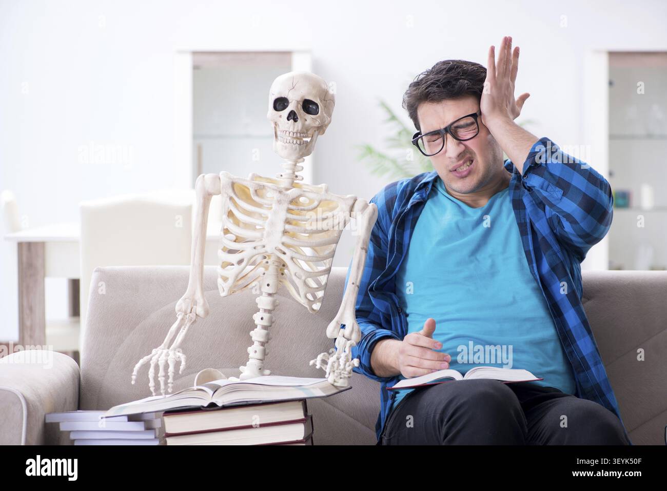 Student studying with skeleton preparing for exams Stock Photo
