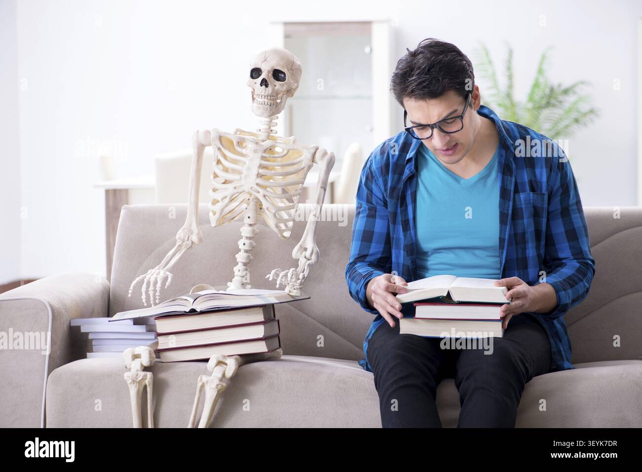 Student studying with skeleton preparing for exams Stock Photo