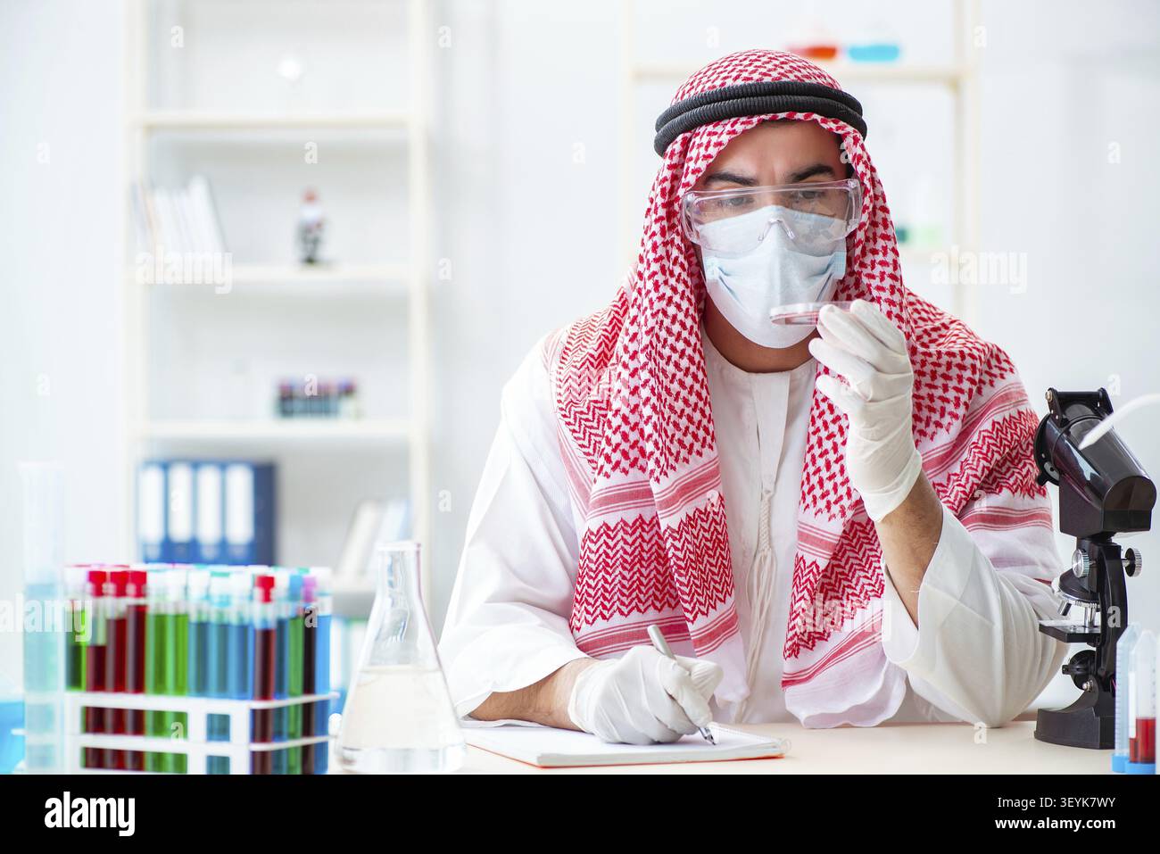 Arab doctor chemist studying new virus in lab Stock Photo