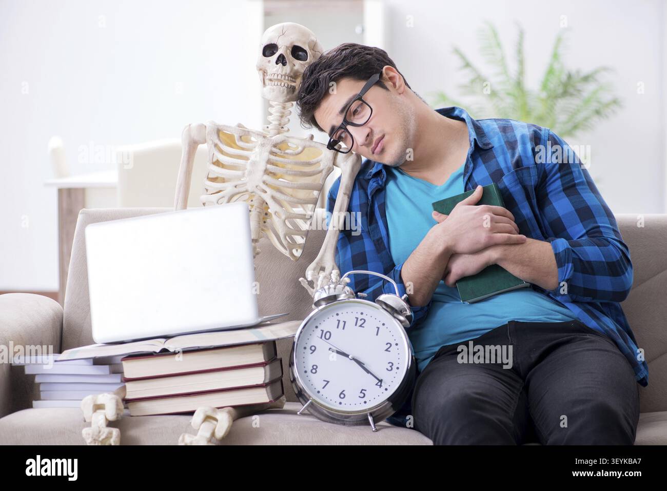 Student studying with skeleton preparing for exams Stock Photo