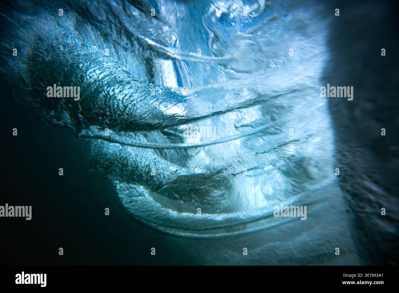 Inside a powerful ocean wave showing light and water textures Stock Photo